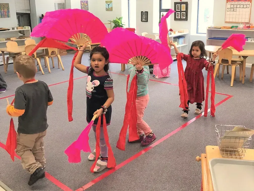 Children dancing with a paper dragon