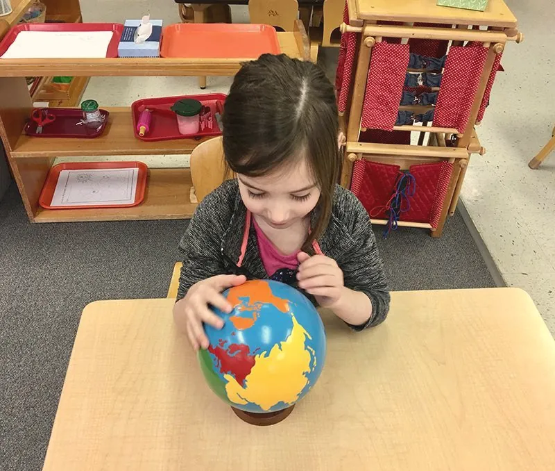 A girl with a puzzle globe