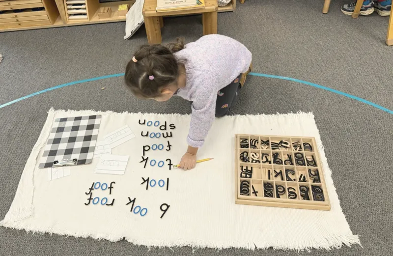 A child building words with the moveable alphabet