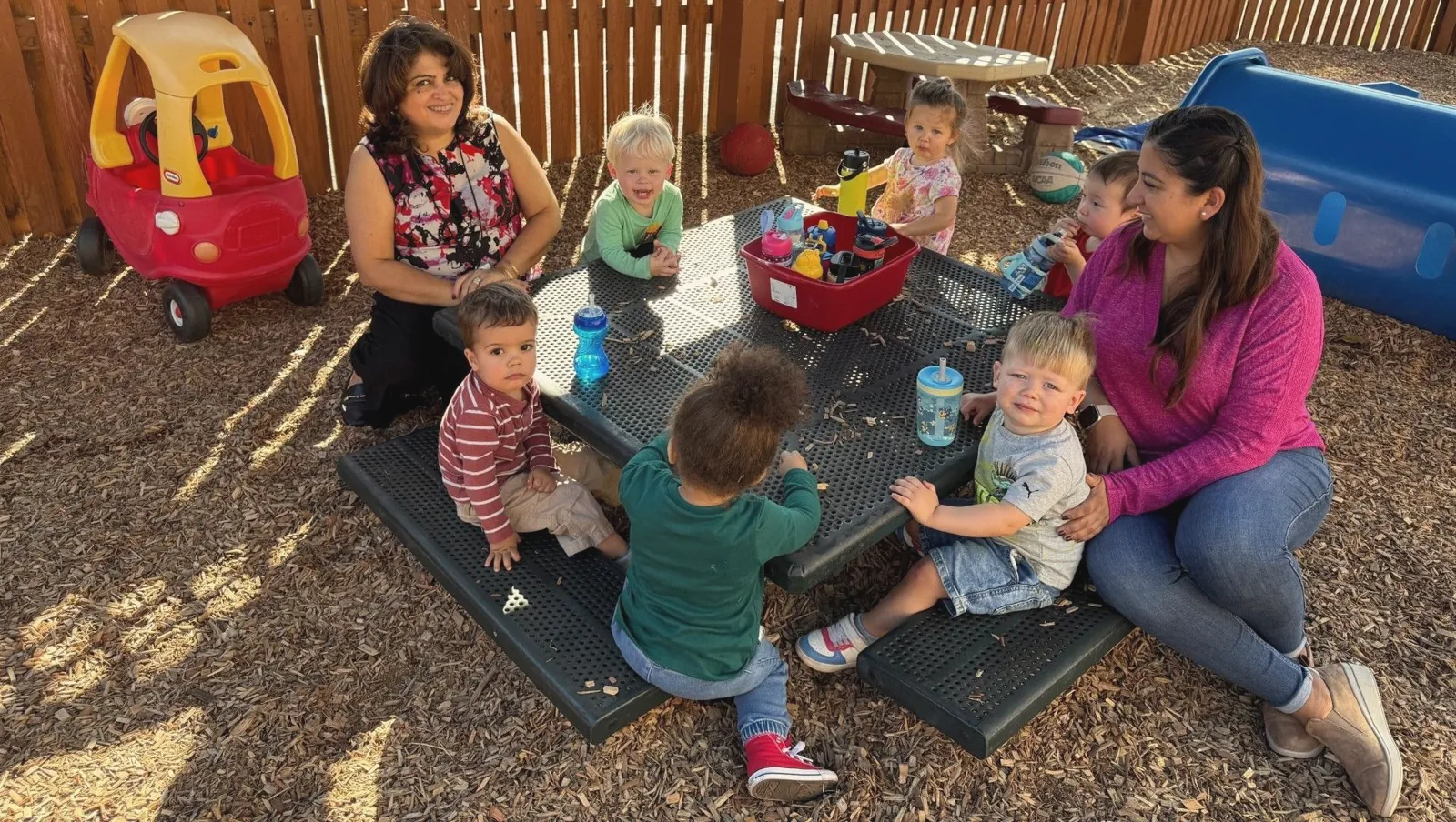 Toddlers and teachers on the playground