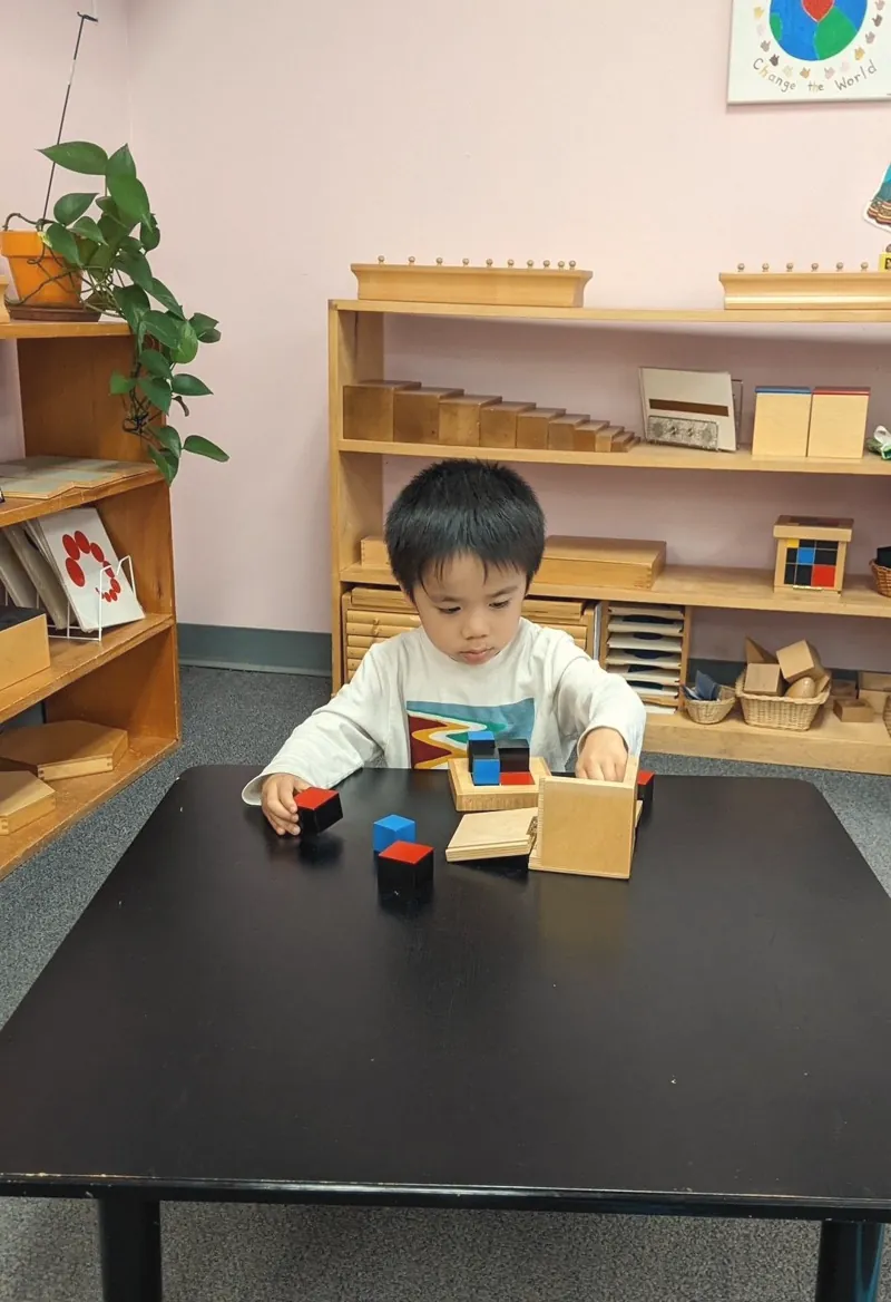 A toddler working at a table